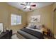 Cozy bedroom featuring a ceiling fan, window with blinds, and stylish decor, creating a relaxing atmosphere at 1435 Orange Jubilee Rd, Henderson, NV 89014