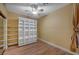 Neutral bedroom with wood floors, ceiling fan, and shelving at 1435 Orange Jubilee Rd, Henderson, NV 89014