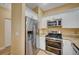 Stylish kitchen featuring stainless steel appliances, granite countertops, and white cabinets at 1435 Orange Jubilee Rd, Henderson, NV 89014