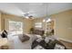 Bright living room showcasing a modern table set, backyard access through sliding glass doors, and a view to the bedroom at 1435 Orange Jubilee Rd, Henderson, NV 89014