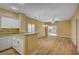 Open-concept living space with wood-look flooring, a ceiling fan, and a sliding door to the backyard at 1435 Orange Jubilee Rd, Henderson, NV 89014