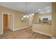 Charming living area with wood-look flooring, a view into the kitchen, and a hallway entrance at 1435 Orange Jubilee Rd, Henderson, NV 89014