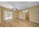 Bright living room featuring wood-look floors, updated lighting, a ceiling fan, and access to the backyard at 1435 Orange Jubilee Rd, Henderson, NV 89014