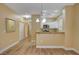 Bright living area with wood-look flooring, a view into the kitchen, and easy access to hallways at 1435 Orange Jubilee Rd, Henderson, NV 89014