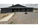 View of the home's back exterior with a gravel yard and hot tub on the back patio at 1830 Justine Ct, Pahrump, NV 89048