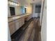 Bathroom featuring dual sinks, vanity and wood-look flooring at 1830 Justine Ct, Pahrump, NV 89048