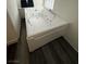 A large, luxurious bathtub featuring jacuzzi jets and wood-look floors at 1830 Justine Ct, Pahrump, NV 89048