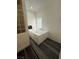 A large, luxurious bathtub featuring jacuzzi jets and wood-look floors at 1830 Justine Ct, Pahrump, NV 89048