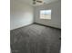 Bedroom featuring a window with a view and soft neutral carpet at 1830 Justine Ct, Pahrump, NV 89048