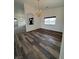 Bright dining room featuring wood floors, a chandelier, and an arched doorway at 1830 Justine Ct, Pahrump, NV 89048