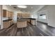 Open-concept kitchen featuring an island, stainless steel appliances, and wood cabinets at 1830 Justine Ct, Pahrump, NV 89048