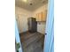 Laundry room with stainless steel fridge and light wood cabinets at 1830 Justine Ct, Pahrump, NV 89048