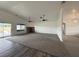 Bright and open living room featuring large windows, a fireplace, and carpeted floors at 1830 Justine Ct, Pahrump, NV 89048