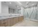Luxurious bathroom featuring double vanity with marble countertops and a large marble-walled shower at 19 Rue Grimaldi Way, Henderson, NV 89011