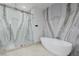 Elegant bathroom showcasing a glass-enclosed shower with marble walls and a freestanding soaking tub at 19 Rue Grimaldi Way, Henderson, NV 89011