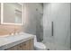 Modern bathroom features a lighted mirror, marble countertop, and frameless glass shower at 19 Rue Grimaldi Way, Henderson, NV 89011