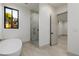 Bright bathroom features a standalone tub, marble shower, and a modern window with natural light at 19 Rue Grimaldi Way, Henderson, NV 89011