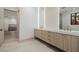 Bright bathroom features double sinks with marble counters and stylish wood cabinets for a spa-like feel at 19 Rue Grimaldi Way, Henderson, NV 89011