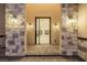 Elegant entryway featuring stone pillars, modern lighting, and a glimpse into the home's contemporary interior at 19 Rue Grimaldi Way, Henderson, NV 89011