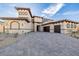 Beautiful exterior of a luxury home with stone accents, a red tile roof, and a three-car garage at 19 Rue Grimaldi Way, Henderson, NV 89011