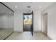 Bright foyer with large windows, light tile flooring, and a modern front door, offering an inviting entrance at 19 Rue Grimaldi Way, Henderson, NV 89011