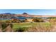 Panoramic view of a lush golf course next to a lake, with mountains in the background at 19 Rue Grimaldi Way, Henderson, NV 89011