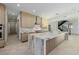 Contemporary kitchen with a marble island, custom cabinets, and sleek appliances at 19 Rue Grimaldi Way, Henderson, NV 89011