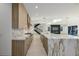 Open kitchen with a marble island, stainless appliances, and views of the living area at 19 Rue Grimaldi Way, Henderson, NV 89011