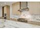 Luxury kitchen with marble countertops, stainless steel appliances, and custom cabinets at 19 Rue Grimaldi Way, Henderson, NV 89011