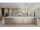 Modern kitchen with a large marble island, light wood cabinets, and designer finishes at 19 Rue Grimaldi Way, Henderson, NV 89011