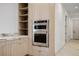 Gourmet kitchen with stainless steel double oven and light wood cabinetry at 19 Rue Grimaldi Way, Henderson, NV 89011