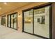 View into a modern, open-plan living room through a glass sliding door at 19 Rue Grimaldi Way, Henderson, NV 89011