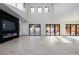 Bright living room features a modern fireplace and expansive sliding glass doors at 19 Rue Grimaldi Way, Henderson, NV 89011