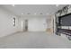 Modern living room with plush carpeting, recessed lighting, and a stunning marble fireplace feature at 19 Rue Grimaldi Way, Henderson, NV 89011