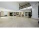 Open-concept living room featuring modern finishes, a bar area, and seamless flow into the kitchen at 19 Rue Grimaldi Way, Henderson, NV 89011