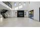 Bright living room with high ceilings, modern fireplace, and large sliding doors, creating a seamless indoor-outdoor flow at 19 Rue Grimaldi Way, Henderson, NV 89011