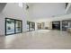 Bright and airy living room with floor-to-ceiling windows and seamless access to a modern bar and kitchen area at 19 Rue Grimaldi Way, Henderson, NV 89011