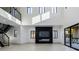Open-concept living room with fireplace, sleek staircase and abundant natural light at 19 Rue Grimaldi Way, Henderson, NV 89011