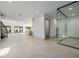 Spacious living room with a modern staircase, large windows, and an open floor plan at 19 Rue Grimaldi Way, Henderson, NV 89011