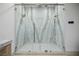 Large, marble-walled shower with dual shower heads and seamless glass enclosure at 19 Rue Grimaldi Way, Henderson, NV 89011