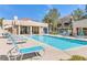 Community pool surrounded by lounge chairs perfect for relaxation and enjoyment at 1900 Mountain Hills Ct # 203, Las Vegas, NV 89128