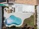 Home's backyard featuring a sparkling pool, covered patio, outdoor kitchen, and well-maintained lawn, perfect for outdoor living at 222 Hollyfern St, Henderson, NV 89074