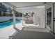 Relaxing covered patio area with pergola overlooking the pool and outdoor kitchen, creating a serene outdoor space at 222 Hollyfern St, Henderson, NV 89074