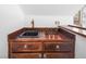 Wet bar area featuring a sink, dark wood cabinetry, and distinctive hardware at 222 Hollyfern St, Henderson, NV 89074