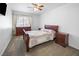 Cozy bedroom featuring a classic wooden bed frame, matching nightstands, and a large window at 222 Hollyfern St, Henderson, NV 89074