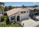Aerial view of a stucco home featuring a tile roof, desert landscaping, and an attached two-car garage at 222 Hollyfern St, Henderson, NV 89074