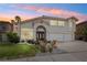 Charming two-story home showcasing beautiful landscaping, green grass, and a desert-style front yard at 222 Hollyfern St, Henderson, NV 89074