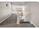 Upstairs hallway with carpet, staircase, kitchen view, and white railing at 222 Hollyfern St, Henderson, NV 89074