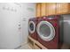 Modern laundry room with front load washer and dryer, along with storage and shelving at 222 Hollyfern St, Henderson, NV 89074