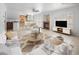 Bright living room with a fireplace, ceiling fan, dining table, and lots of seating at 222 Hollyfern St, Henderson, NV 89074